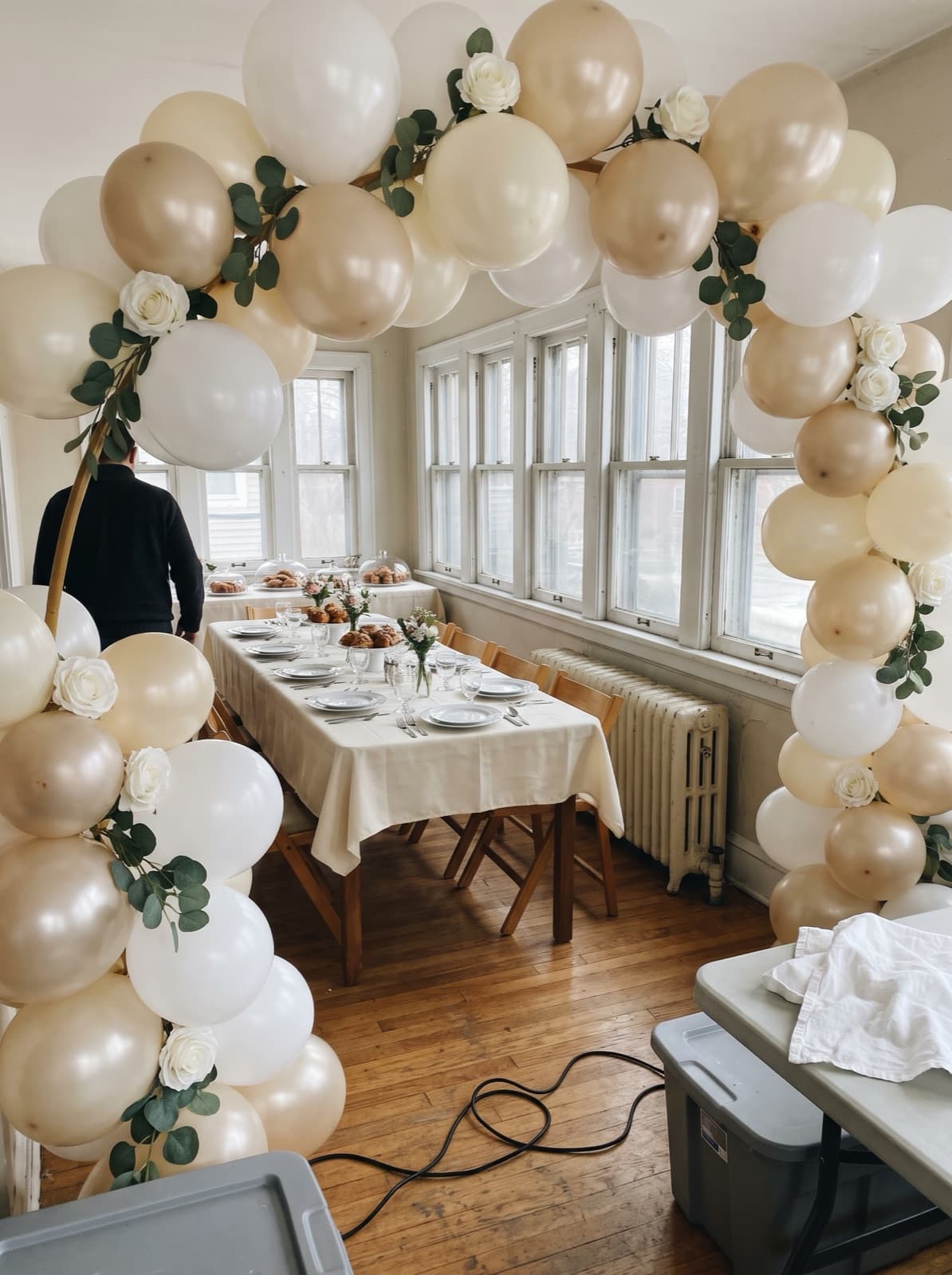 Floral balloon arch with roses and eucalyptus for a bridal shower brunch