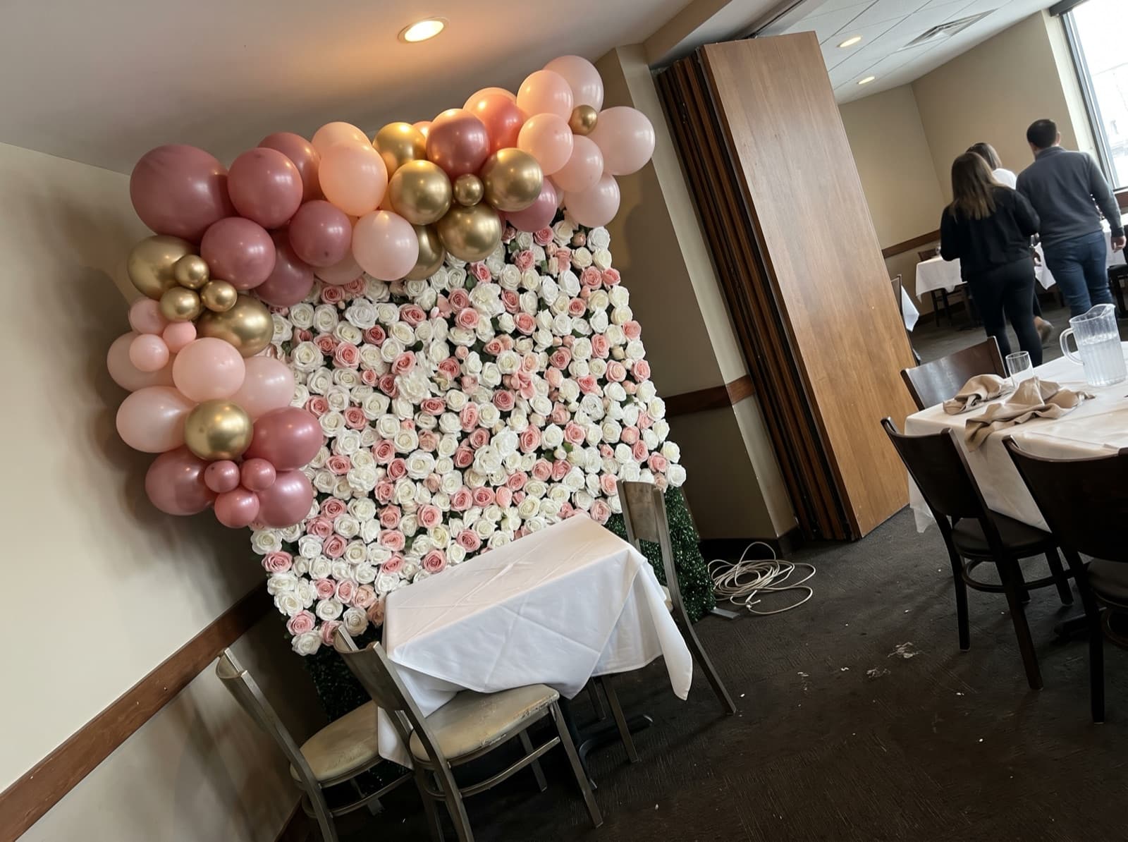 Flower wall backdrop with a blush and gold balloon garland