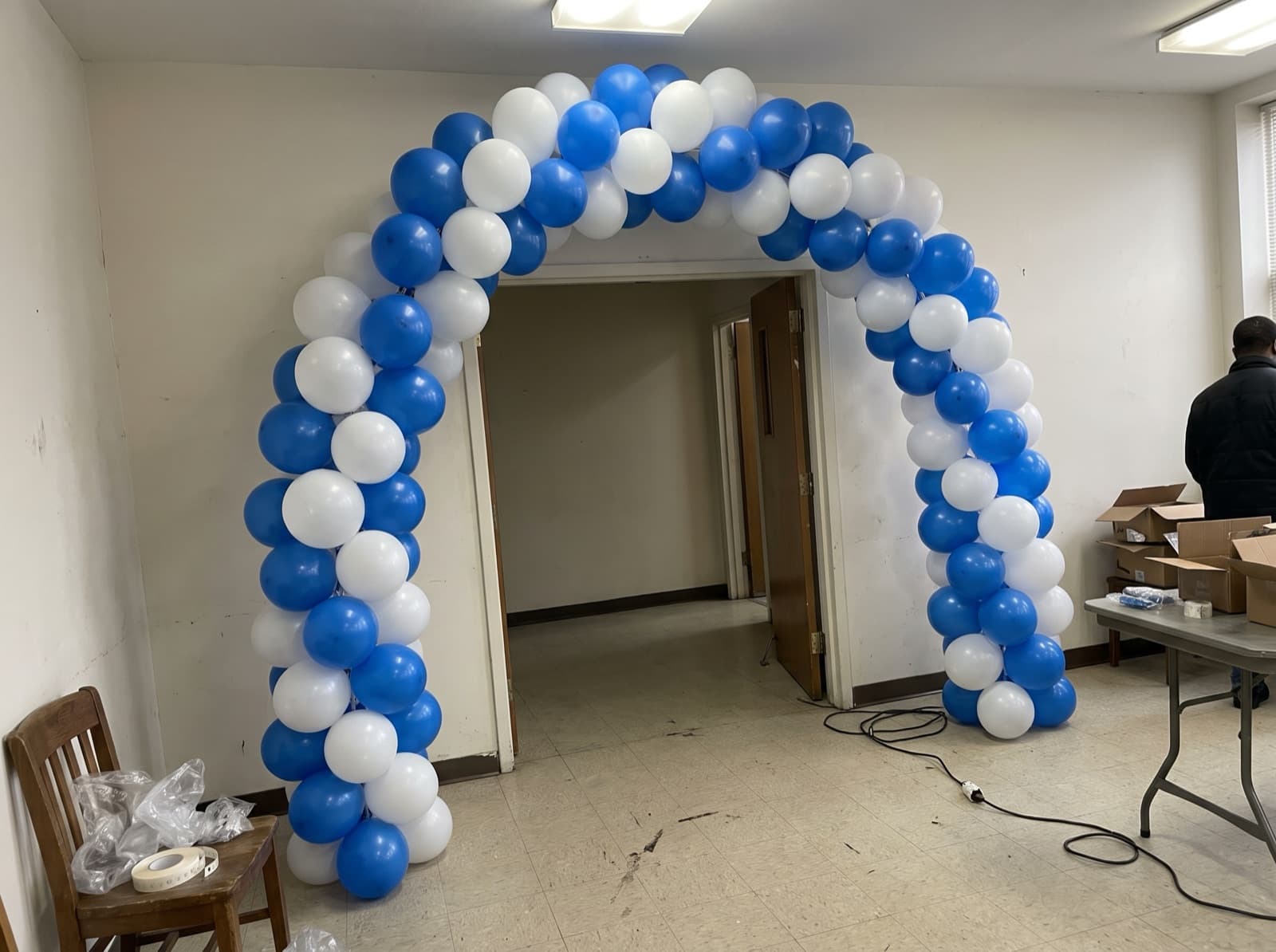 Blue and white balloon columns joined by an arch at a hall entrance