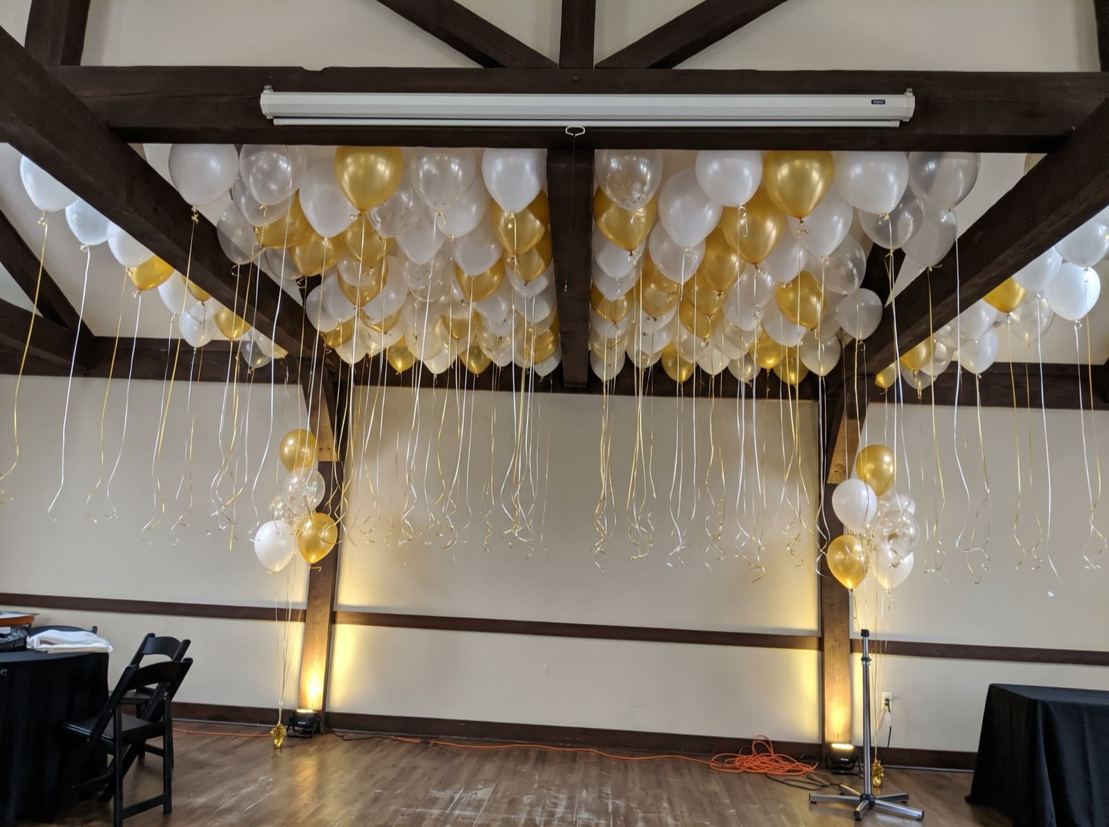 Balloon ceiling under exposed wooden beams in a loft