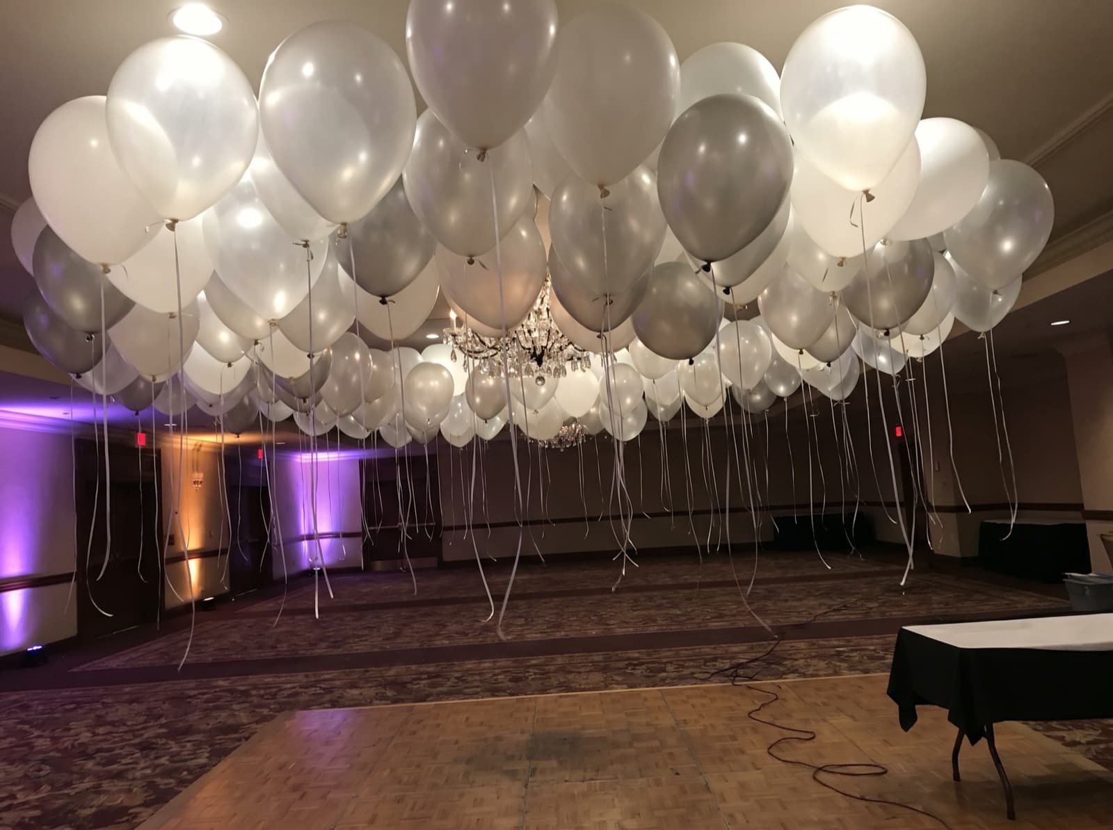 Balloon ceiling of white, clear and silver balloons over a dance floor in a Chicago hotel ballroom