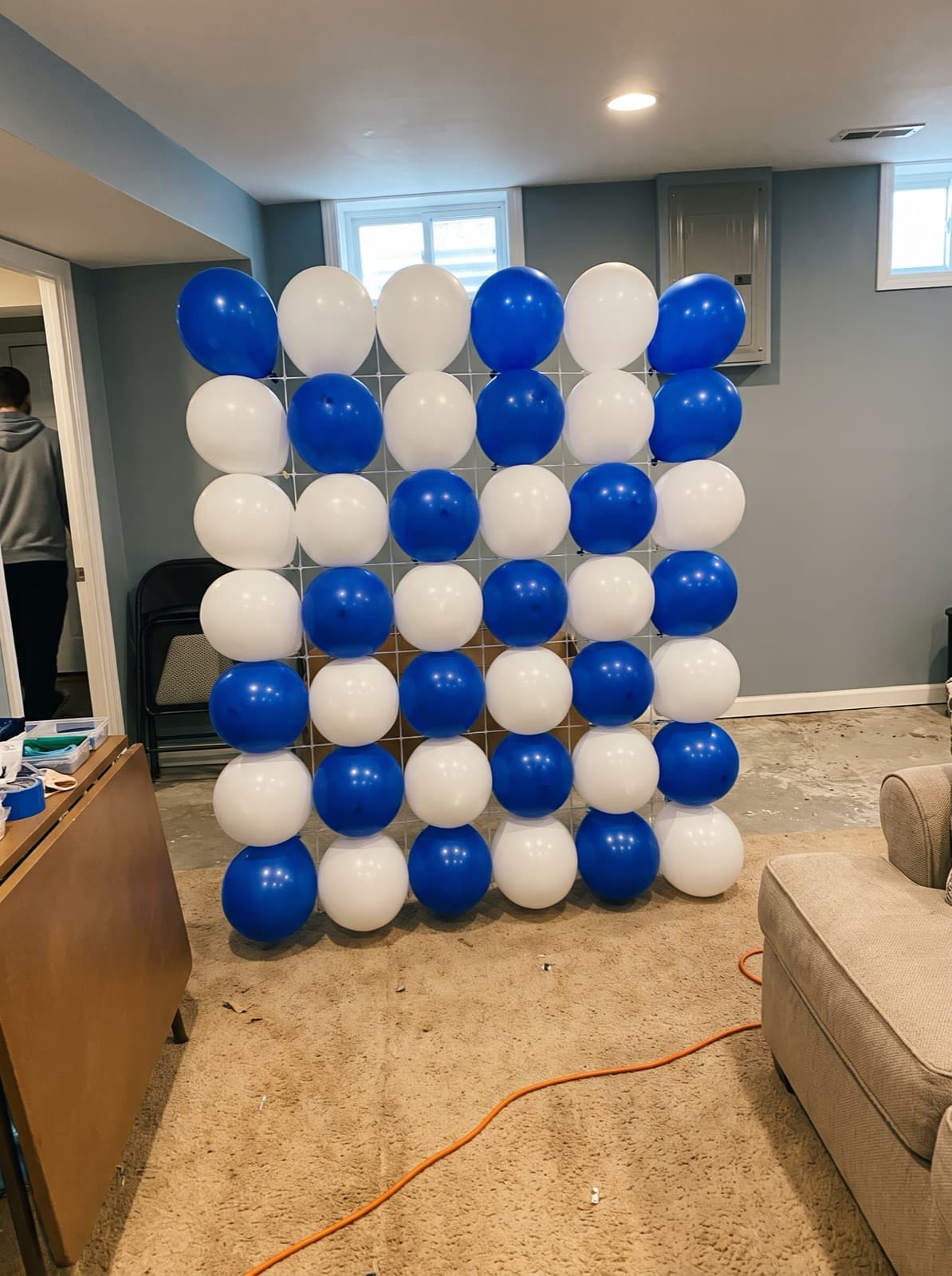 Grid balloon wall in a royal blue and white checkerboard
