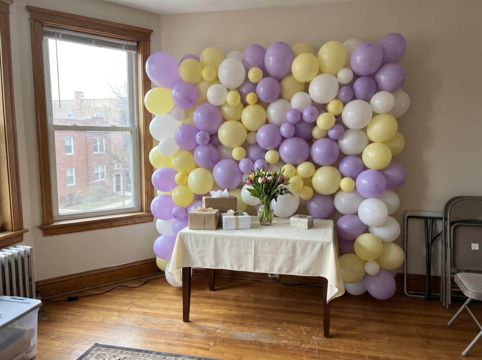 Pastel balloon wall in lavender, butter yellow and white for a baby shower
